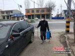 王克粟在给村民车辆进行消毒。 杨午 摄 - 中国新闻社河北分社