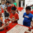 图为张岳（左一）正在指导几位儿童“解密”鲁班锁。　翟羽佳　摄 - 中国新闻社河北分社