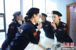 图为女子特警巡逻队队员整理妆容。　白云水 摄 - 中国新闻社河北分社