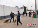 村民们在打扫街道。 李亚涛 摄 - 中国新闻社河北分社