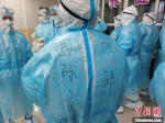 医疗队员在衣服上写下鼓励的话语 田梓成 摄 - 中国新闻社河北分社