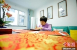 图为河北省大厂民间刻纸艺人张翠梅正在创作冬奥主题刻纸作品。　刘亮 摄 - 中国新闻社河北分社