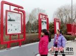 两名小学生在观看宪法主题公园冉庄地道战精神展览。 王俊 摄 - 中国新闻社河北分社