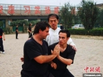 图为2004年，刘连俊正在指导外国武术爱好者进行八极拳对练。　青县县委宣传部供图 - 中国新闻社河北分社
